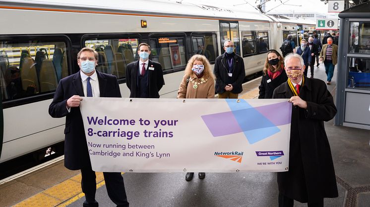Mayor of Cambridgeshire and Peterborough Combined Authority James Palmer (left) holds a banner with Daniel Zeichner MP to celebrate the introduction of longer 8-carriage Great Northern trains between Cambridge and King's Lynn