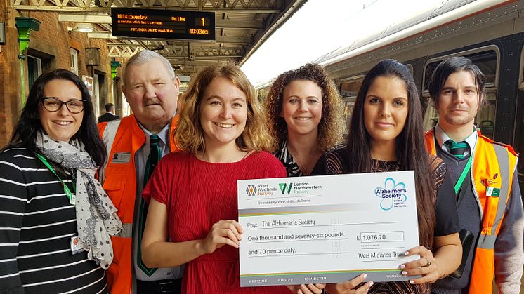 West Midlands Railway and London Northwestern Railway staff hand over the first donation of lost property money to Alzheimer's Society at Nuneaton station