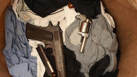 Image of loaded gun and revolver from Heyford Ave