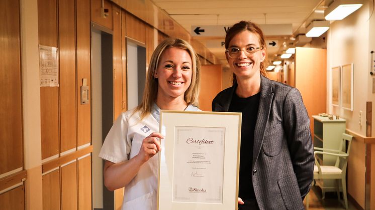 Jenny Norrgren, uroterapeut vid Kvinnokliniken i Skellefteå, tar emot ett diplom av Malin Dankel, ordförande i patientföreningen Sinoba.