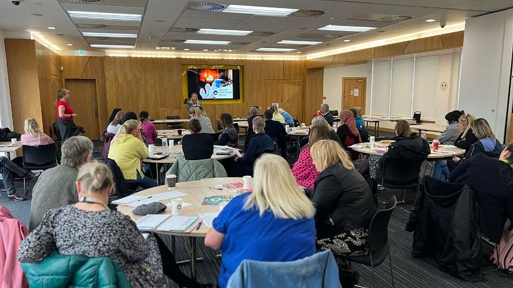 Attendees listening to a presentation during an ng homes' Community Networking Breakfast.