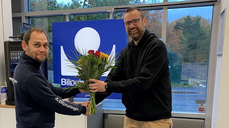 Stationens första kund Magnus Nordin firades med en bukett blommor. Foto: Bilprovningen