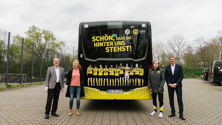 Svenja Schlenker (Abteilungsleiterin Frauenfußball BVB) und Marina Jung (Kapitänin) bekommen den Bus von Hubert Jung und Jörg Jacoby übergeben.