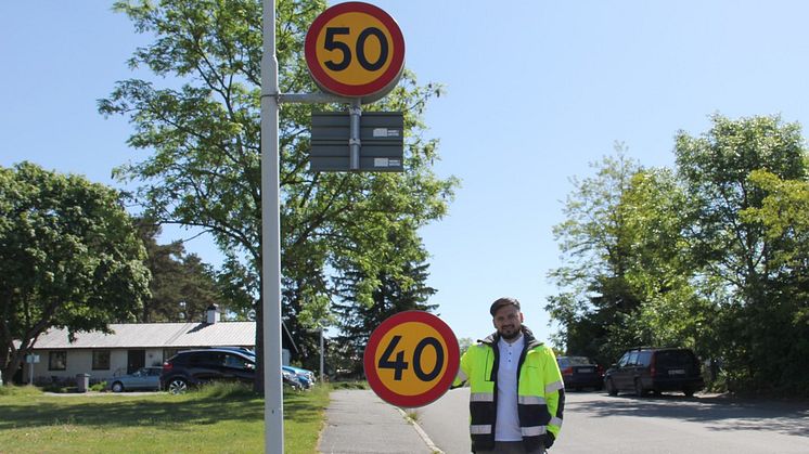 Trafikingenjör Farhad Asekzai håller upp den nya 40-skylten.