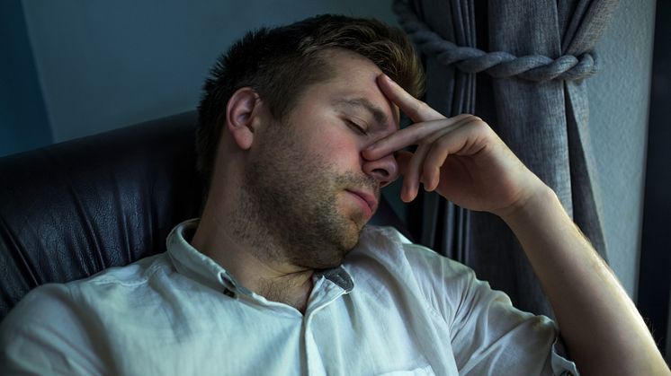 37776080-side-view-of-a-tired-caucasian-man-sleeping-on-a-couch