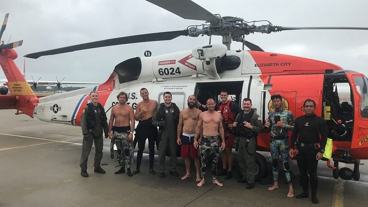 US Coast Guard Fifth District Command Center personnel with the fishermen saved this summer off Cape Henry. Credit: USCG