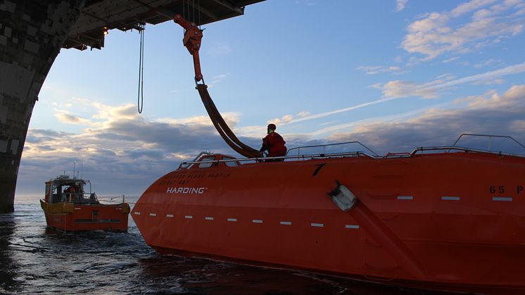Crew from 'Esvagt Dee' rigging one of the lifeboats