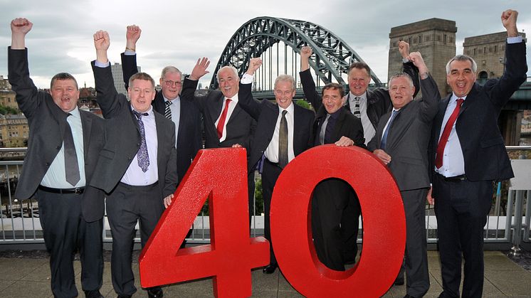  L-R: Robert Harvey, David Tone, Gary Manning, Stephen Millen, Kevin Carr, William Brown, Malcolm Birkett, David Robinson, Barry Newton, in front of the iconic Tyne Bridge.