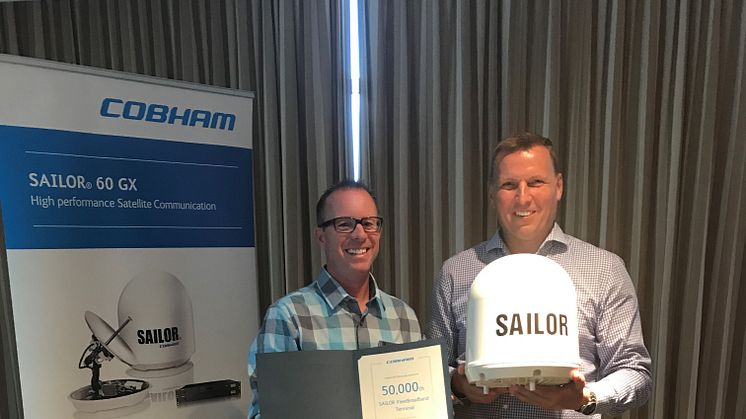 Cobham SATCOM's Henrik Fyhn presents the 50,000th SAILOR FleetBroadband terminal to Matt George (left) of Network Innovations
