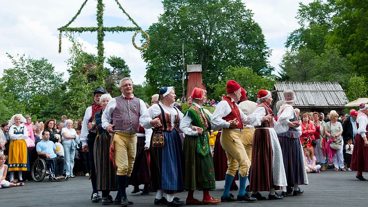 Dancers wearing Swedish traditional costume celebrate Midsummer and the bounties sun and water bring to the planet