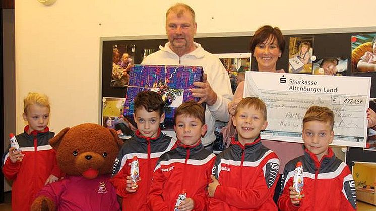 Hugo, Logan, Ben Jonas und Jayden (v.l.n.r.) mit Trainer Udo Barth und Constanze Weiß vom Kinderhospiz Bärenherz präsentieren stolz den Spendenscheck