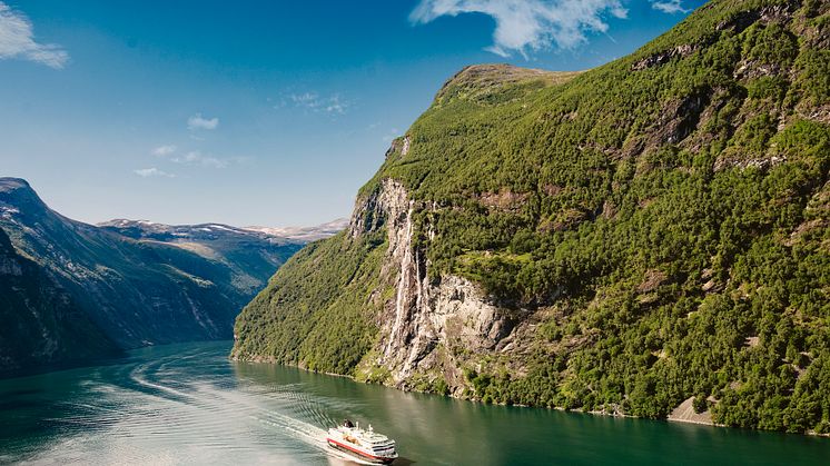 A Hurtigruten ship traveling through Geirangerfjord in Norway. Photo: Agurtxane Concellon