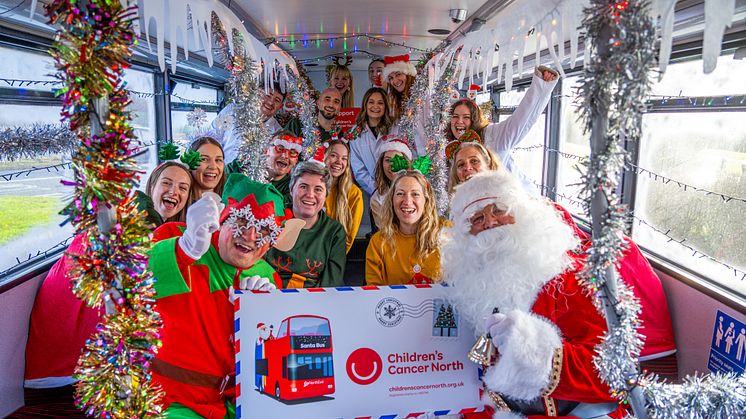 Go North East's Santa and Elf with staff from Children's Cancer North