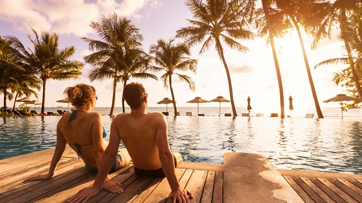 summer-couple-enjoying-beach-holidays-1133594107.jpg
