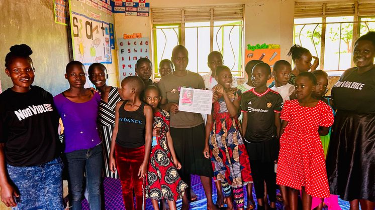 NVP Uganda_Students in classroom w happy teacher.jpg