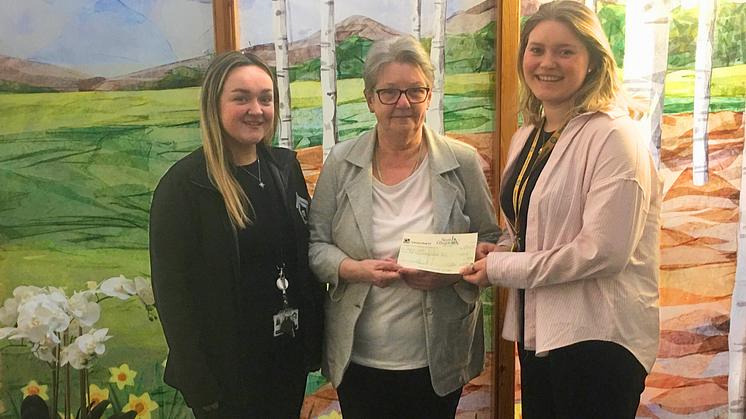 ng home Chairperson Catherine Rossine presents Marie Curie donation 