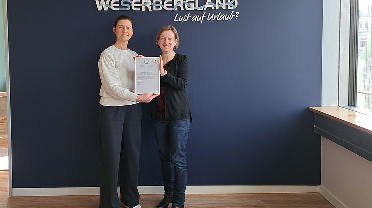 Dorina Brunke und Jessica Dolle vom Weserbergland Tourismus e.V. präsentieren die aktuelle Auszeichnung mit dem Zertifikat "ServiceQualität Deutschland"