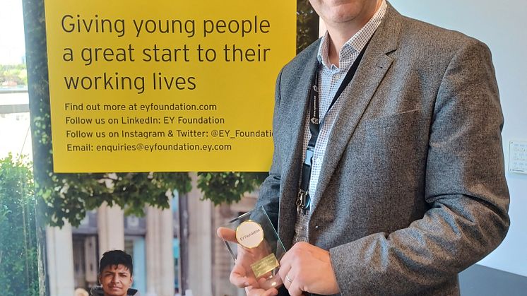 ng homes Project Manager Greg Cann displays his EY Foundation External Volunteer award.jpg