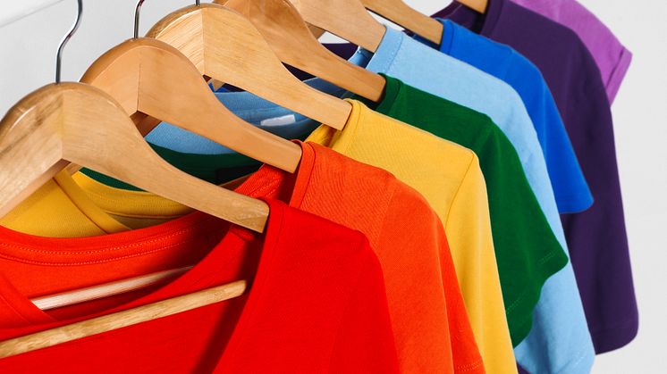 Colorful clothes on hangers against white background - original (1464260).jpeg