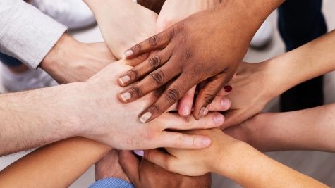53384144-diverse-people-stacking-hand-together-2