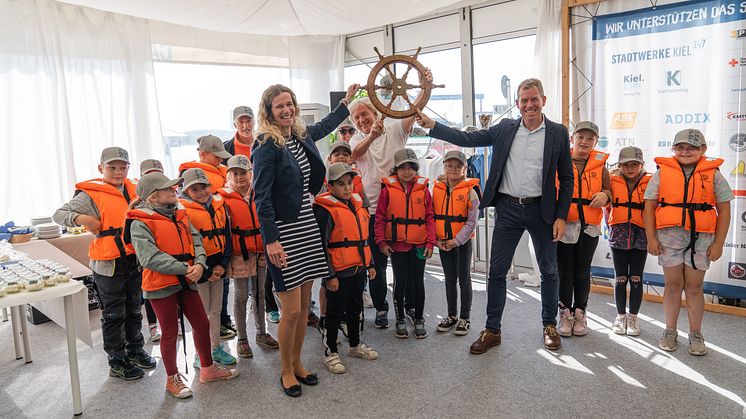 Die Sailingkids der Fritz-Reuter-Schule übergeben das Steuerrad zurück an die Stadtwerke Kiel, Kiel-Marketing und den Oberbürgermeister