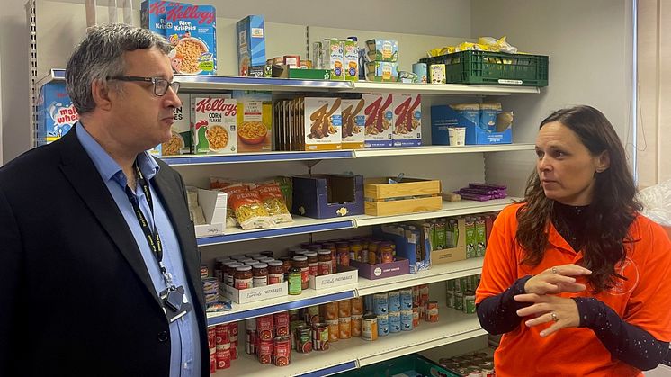 Katie Jenkinson from the Trust House shows Cllr Gold how the food pantry works and explains about the other services Trust House provides