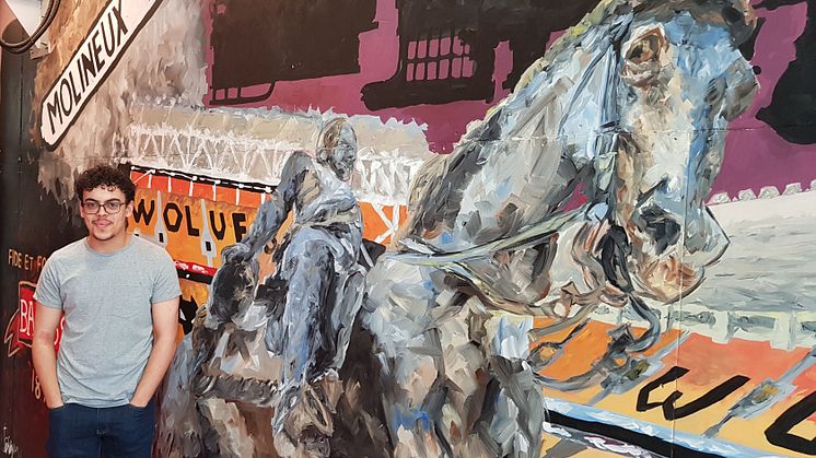 Student Coree Bridgen with his artwork at Wolverhampton station