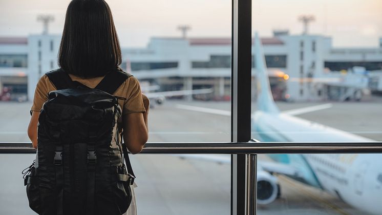 THEME_TRAVEL_AIRPORT_AIRPLANE_WOMAN_TOURIST_STANDING_WITH_LUGGAGE_GettyImages-1312931220_Universal_Within usage period_99798