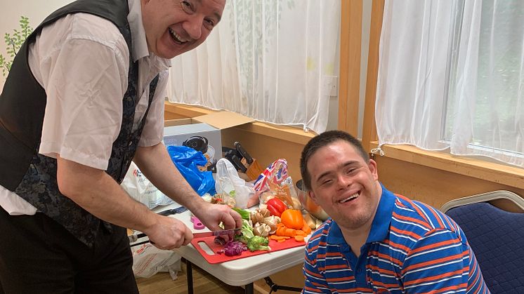 Pictured is Jonny Wineberg from Jewish Action for Mental Health demonstrating how to cook on a budget with Friendship Circle member Ellis Leigh
