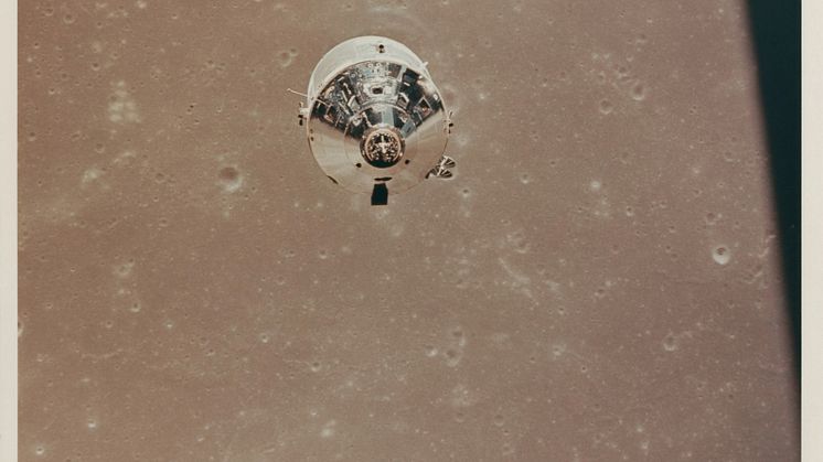 The CSM Columbia over the Sea of Fertility, as seen from the LM descending to the lunar surface.jpg