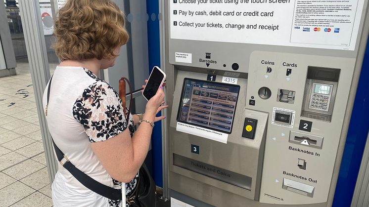 Linn Davies is guided to a ticket machine at Brighton station using the Aira app