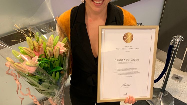 En glad Sandra Petersson med utmärkelsen Årets yrkeslärare. Foto: TYA.