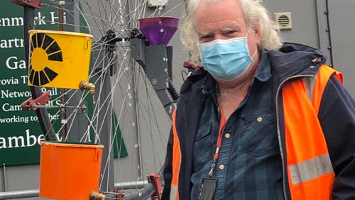 Tony Coleman with his "chaos water wheel" at Denmark Hill station