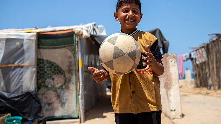 CH11039533_Shadi (8) plays football near his tent in Gaza.jpg