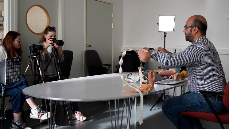Mohammad Sobuh, assistant professor and prosthetist/orthotist, demonstrates alternative designs of arm prostheses. Behind the camera is Ukrainian film crew Anna Borysova and Anna Vialova.