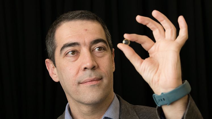 Professor Hamdi Torun, pictured holding the contact lens, developed to detect early signs of glaucoma.