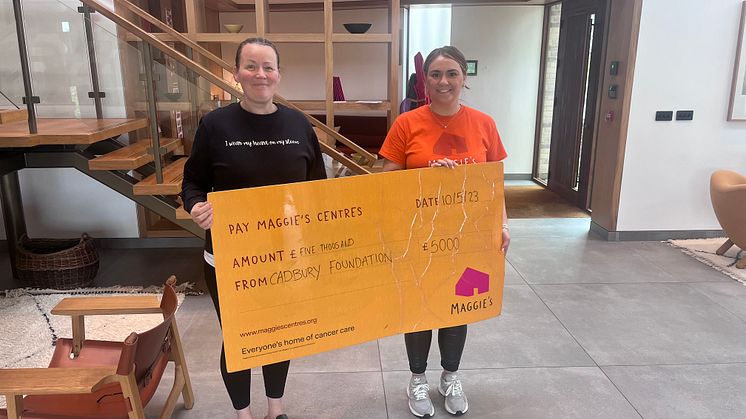 Mondelēz International employee Jemma and Maggie’s Wirral worker holding the cheque from The Cadbury Foundation