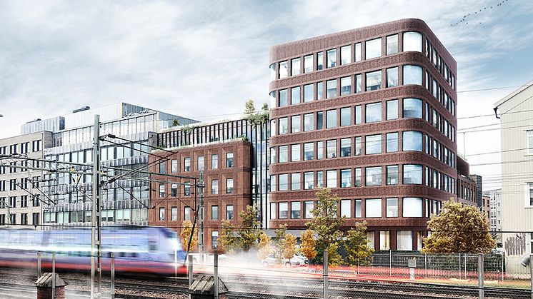 Visionsbild för hur det nya kontorshuset kommer att upplevas från järnvägssidan. Illustration: Kamikaze Arkitekter