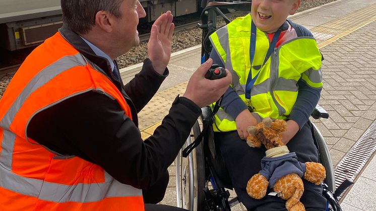 Station manager Joe Healy helps Alfie make announcement at Luton Airport Parkway station.jpeg