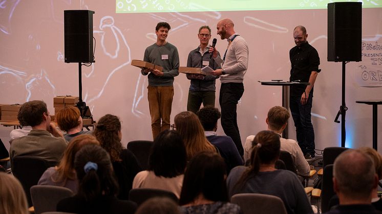Kraftringens domare Olle Eliasson delar ut pris till Orange Peelers Henry Cronholm-Levin och Daniel Klint. Den tredje medlemmen i Orange Peelers var Hande Dogan. 