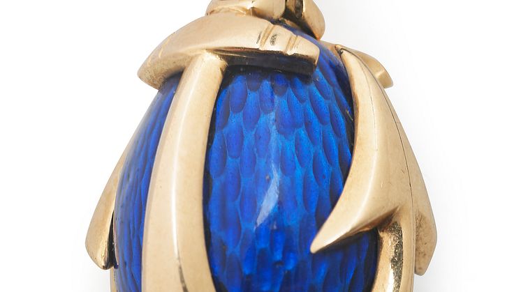 August Holmström: A Russian Easter egg pendant with blue translucent enamel on guilloched ground, set with anchor formed 14k gold cagework.