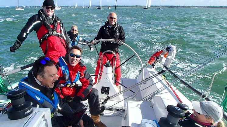 Story image - Ocean Signal - Sailor Simon Grier-Jones, pictured at the helm on another occasion, fell overboard while sailing in the Solent and was successfully recovered following the activation of his Ocean Signal rescueME MOB1