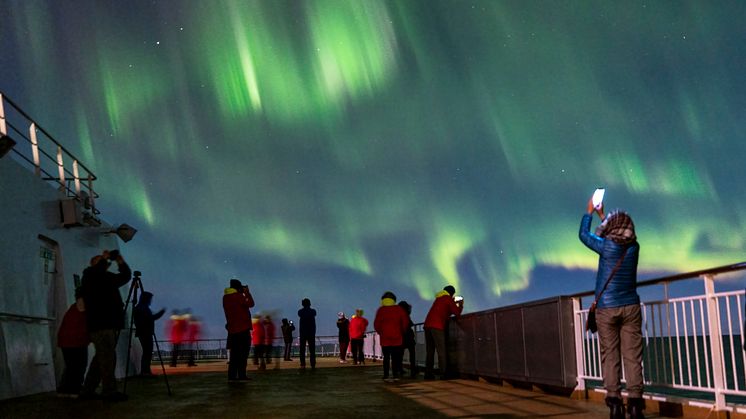 Guests onboard Hurtigruten's Original Coastal Express enjoying the Northern Lights. Photo: Tommy Simonsen
