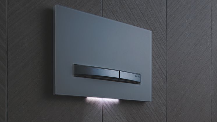 Geberit Sigma50 -huuhtelupainike yövalo päällä