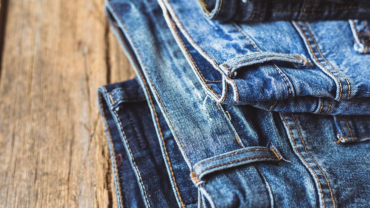 Jeans stacked on a wooden background - original (1464265).jpg