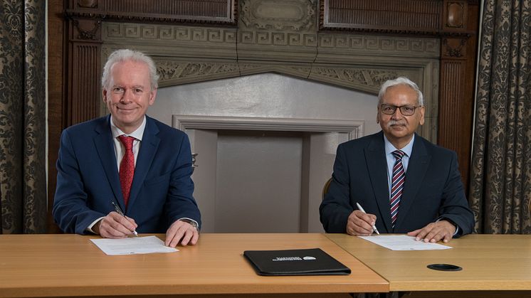 Professor Andrew Wathey signing the partnership agreement with Professor Saleemul Huq
