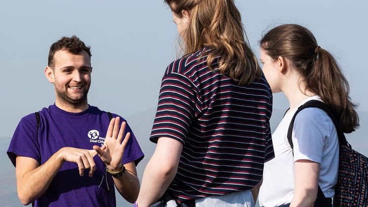 A National Deaf Children’s Society staff member using sign language to communicate
