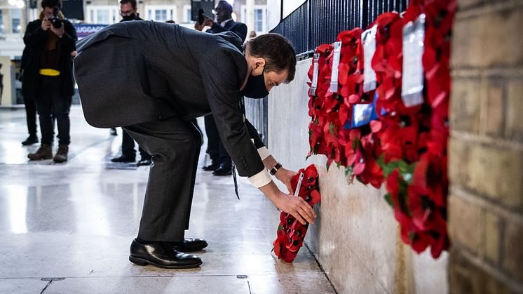 Chris Fowler from Southern lays a wreath next to the commemorative plaque for the Unknown Warrior at Victoria station