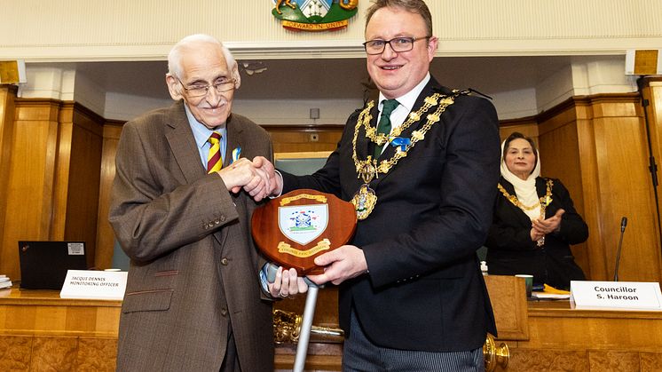 Colonel Eric Davidson is presented with his commemorative shield by the Mayor of Bury, Cllr Tim Pickstone.