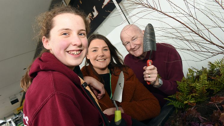 Great Linford Scouts, railway staff and volunteers fill planters at Milton Keynes station